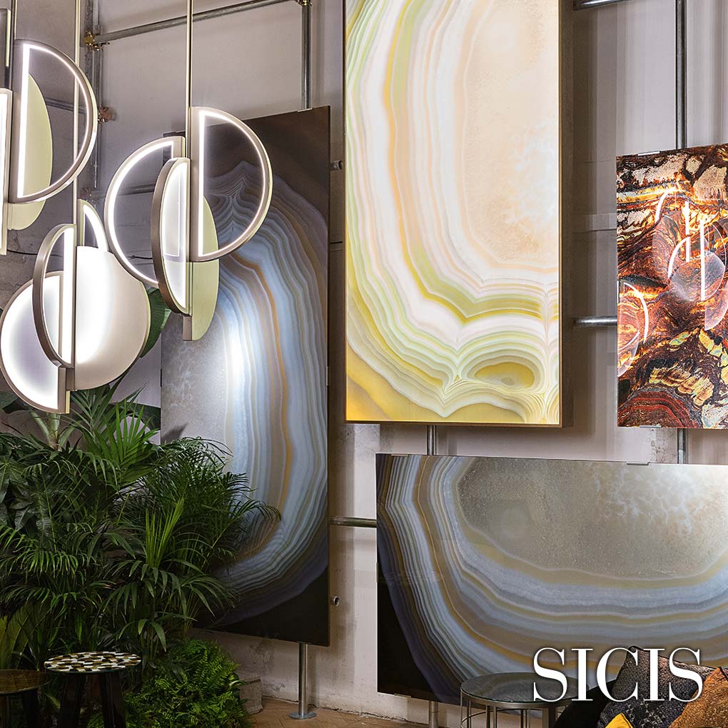 A wall of glass panels with designs reminiscent of the interiors of geodes.